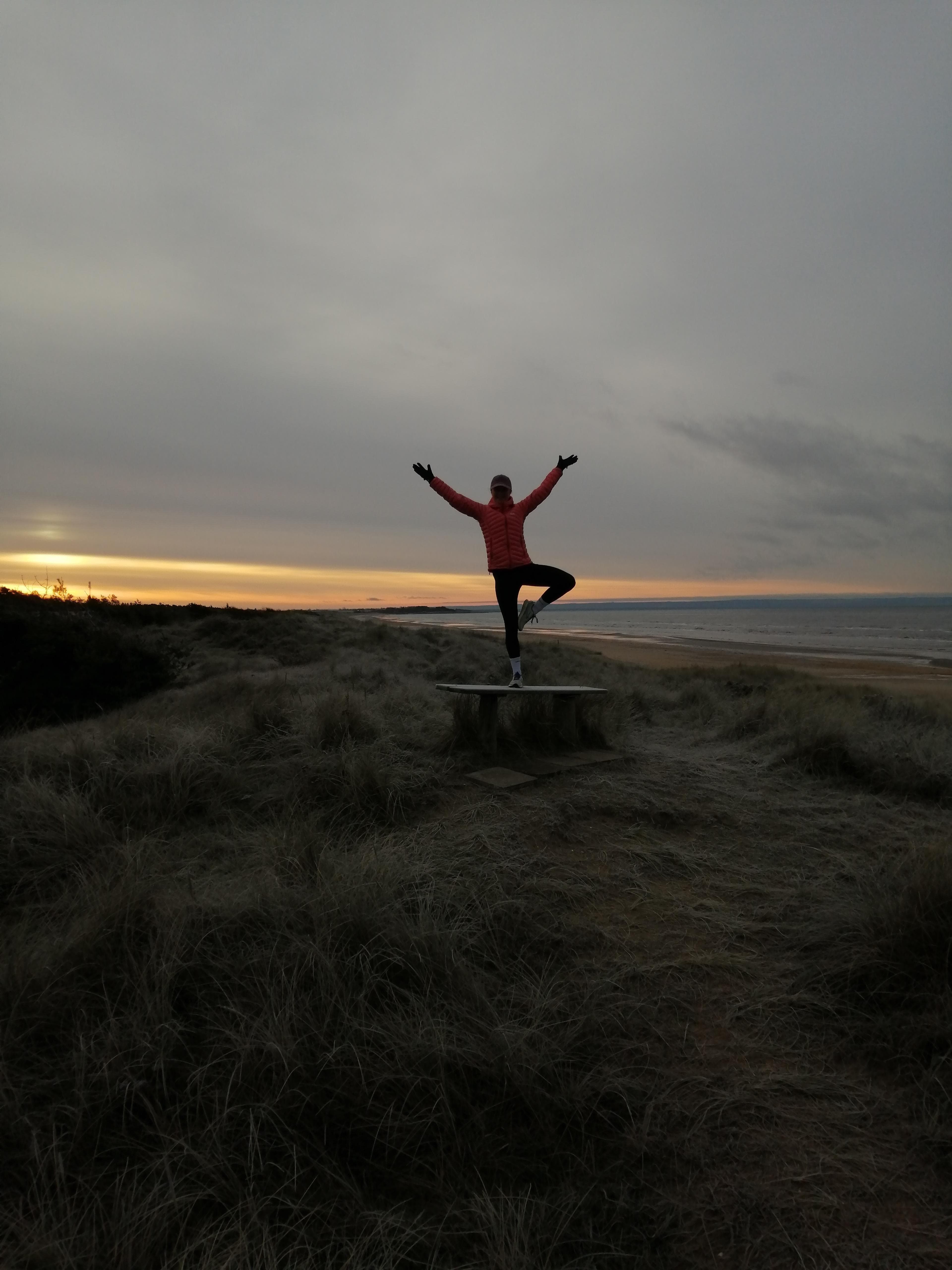 Maria doing yoga on the beach